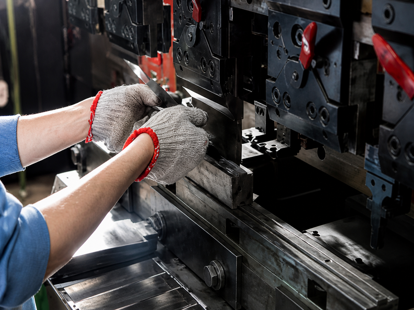 Operator positioning a sheet metal part at a press brake